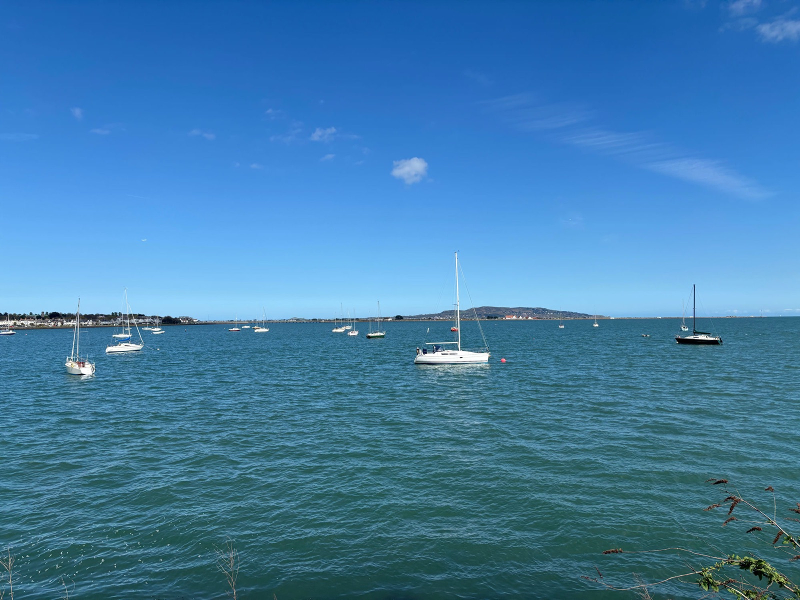 Sailboats moored on Dublin Bay off Clontarf, with Howth Head in the distance