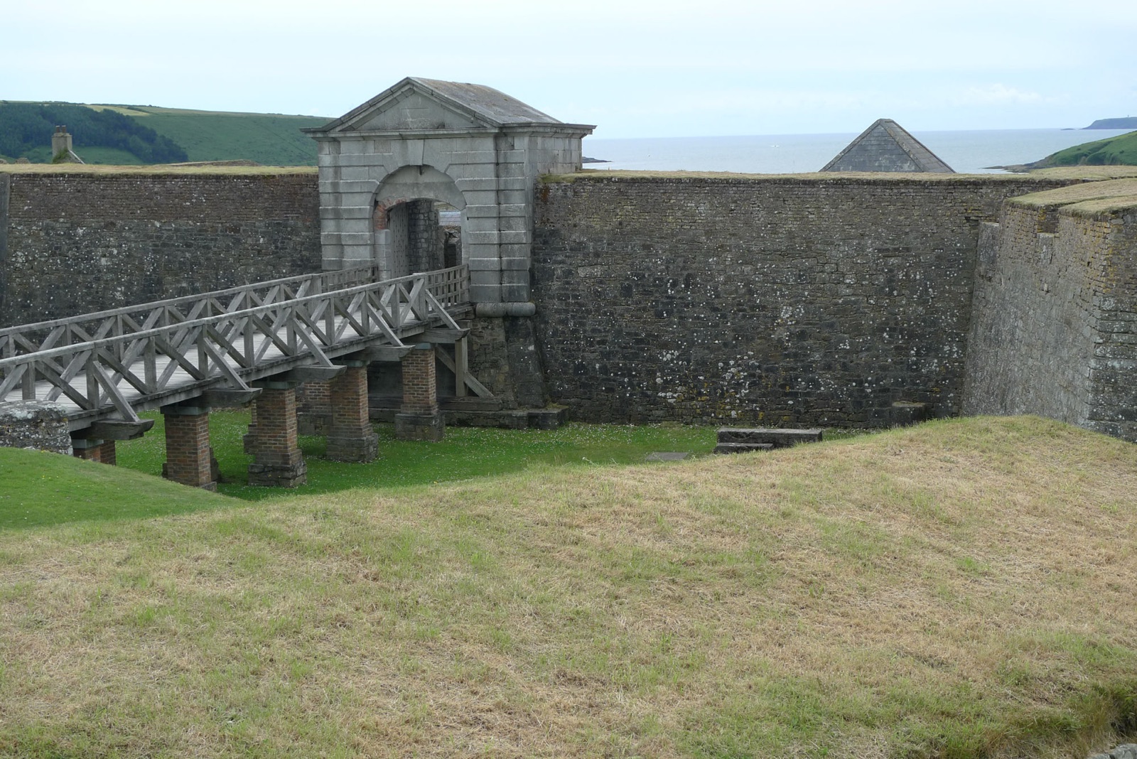 The classical entrance gateway and wooden footbridge of Charles Fort, the 17th-century star fort overlooking Kinsale harbour in County Cork